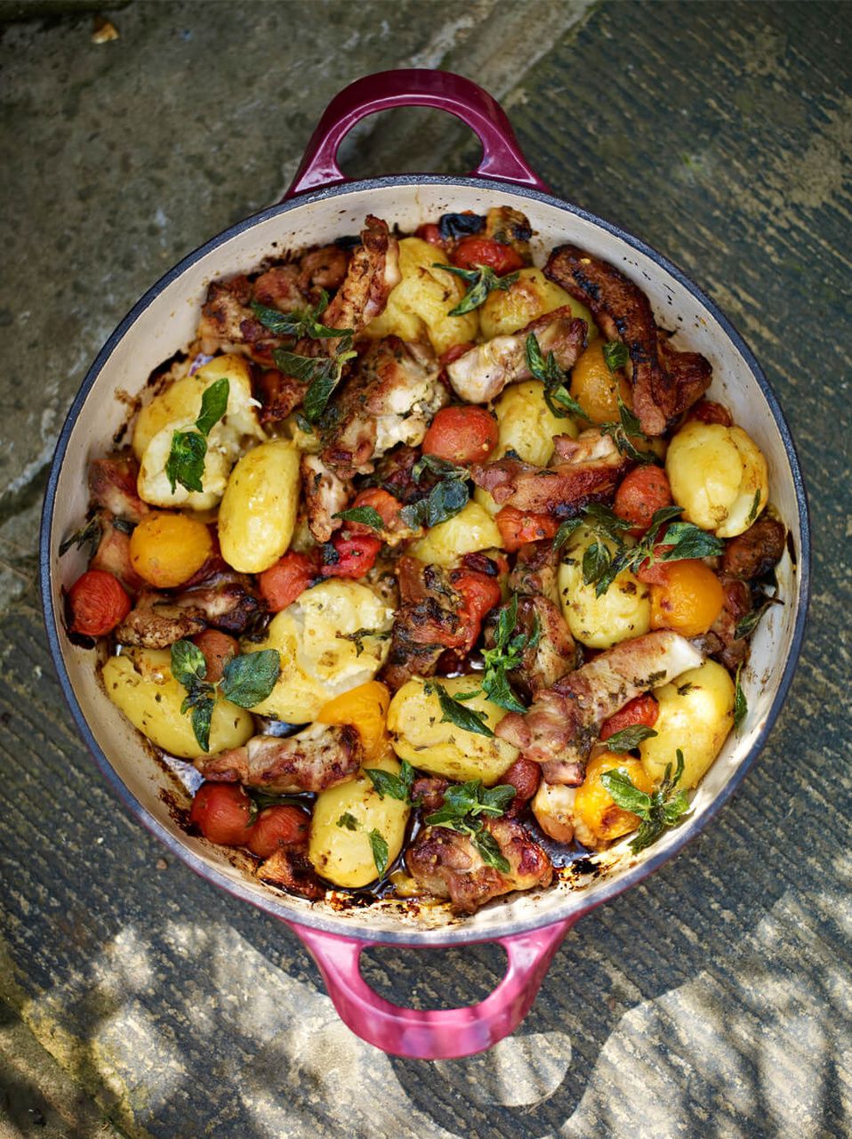 Crispy & sticky chicken thighs with squashed new potatoes & tomatoes