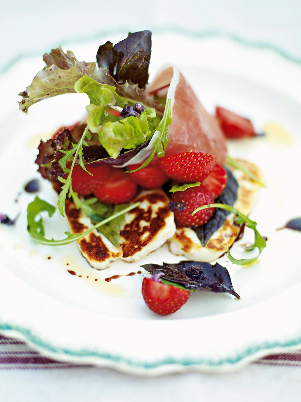Strawberry salad with speck and halloumi
