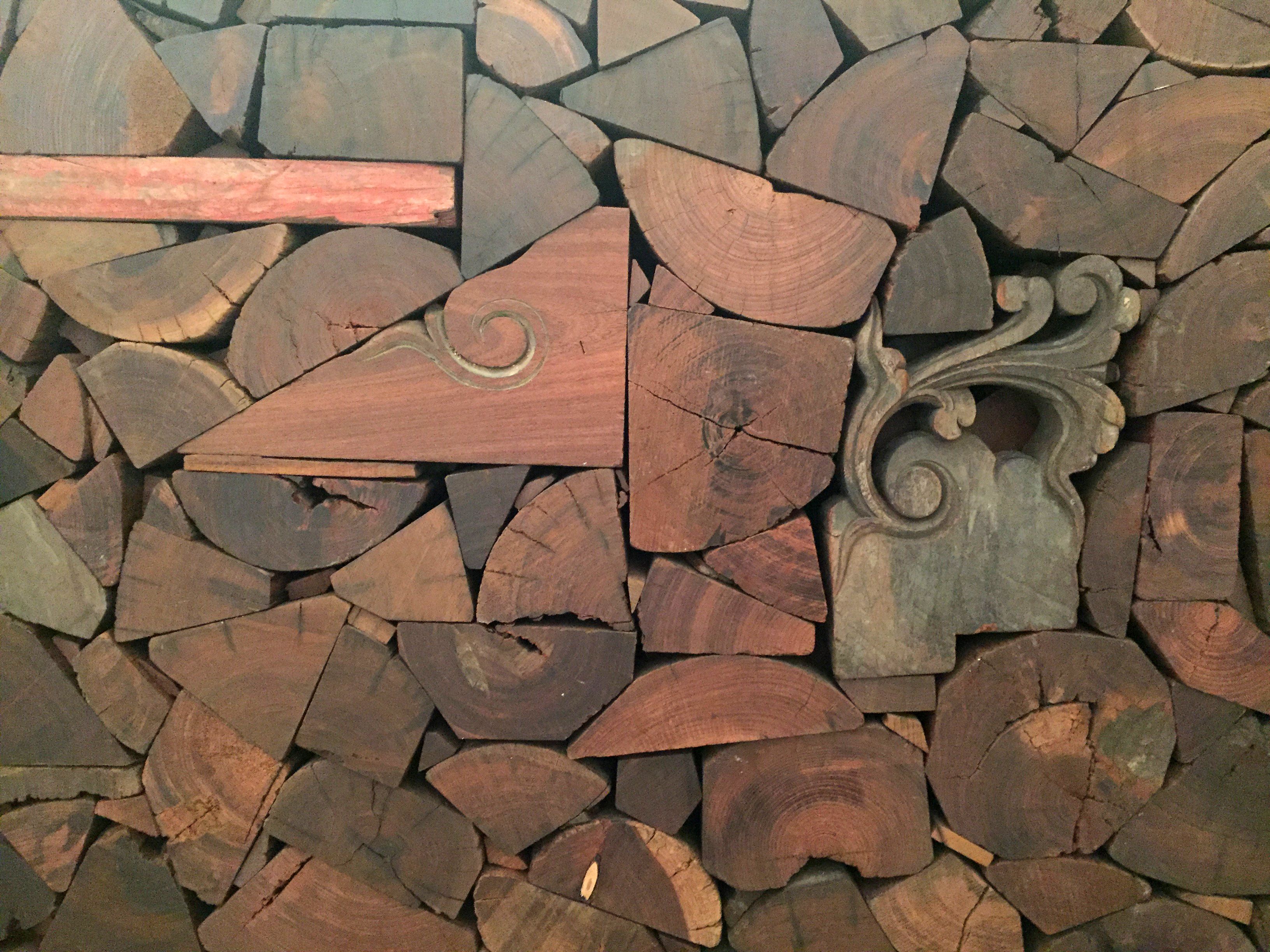 End on irregular timber blocks with inset decorative pieces from an instalation by Ai Wei Wei at the Royal Academy