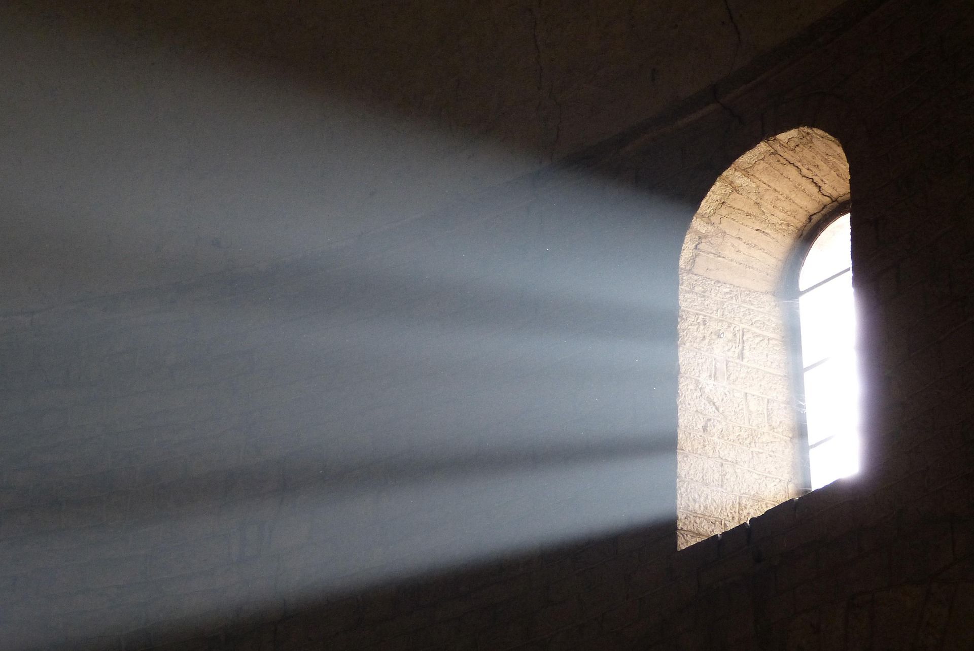 light coming in through a high level window into a dark room
