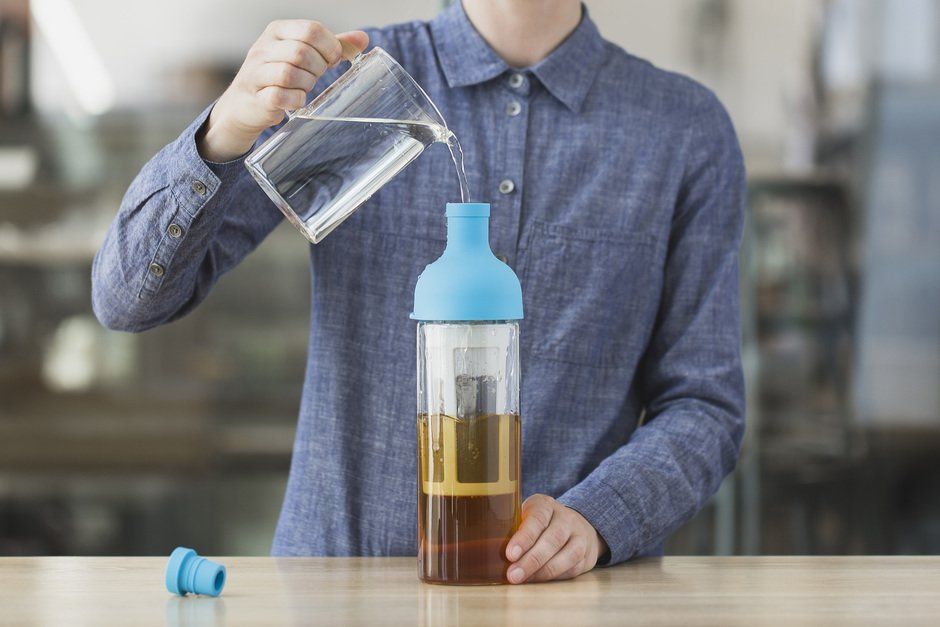 pouring cold water into the cold brew bottle