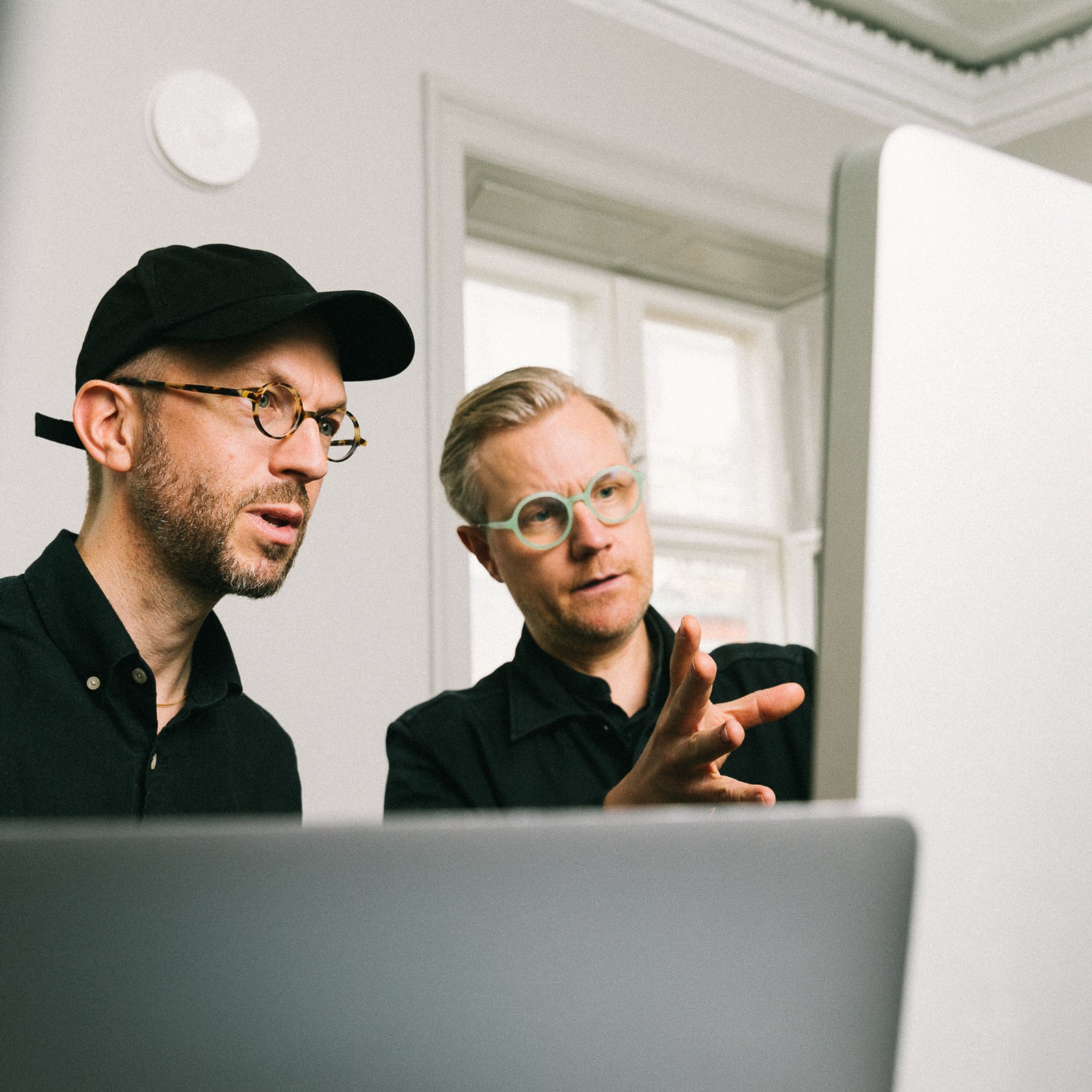 Two men working at computer in design studio