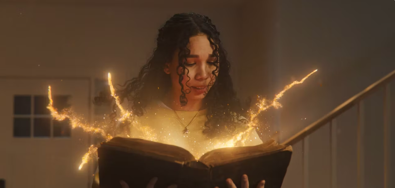 girl looking into a glowing book