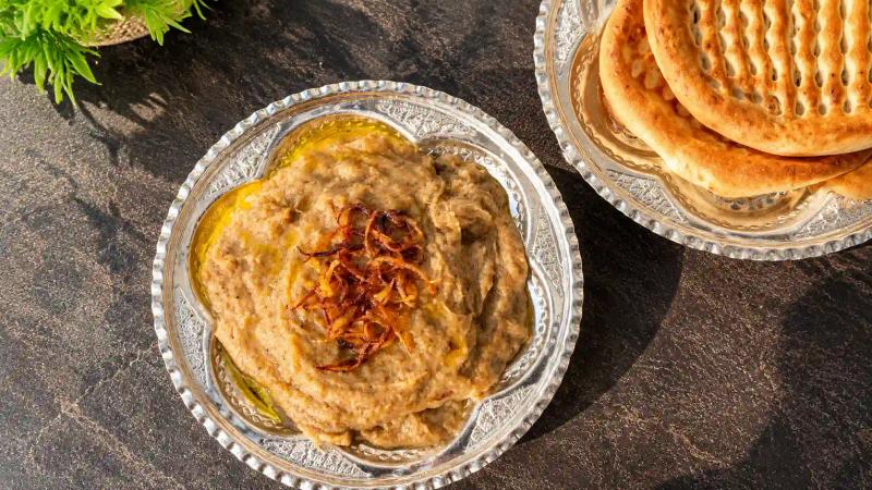 Kashmir winter food and culture featuring traditional Harrisa served with freshly baked Kashmiri bread.
