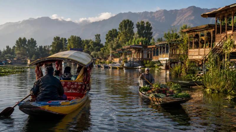 Dal Lake shikara ride passing a floating vegetable market and traditional houseboats in Srinagar.