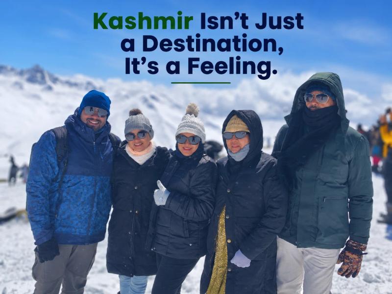Happy travellers enjoying the snowy mountains of Kashmir with a trusted Kashmir Travel Agency.
