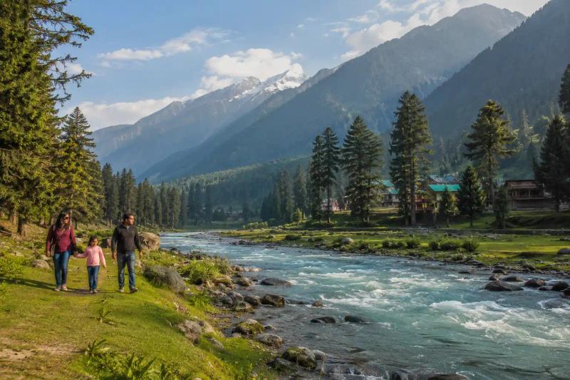 Kashmir 4N/5D Tour Package featuring a family walking beside the Lidder River amid the green valleys and mountains of Pahalgam.