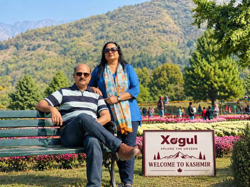 Kashmir tour package price per person: couple enjoying a Xogul trip in a Kashmir garden