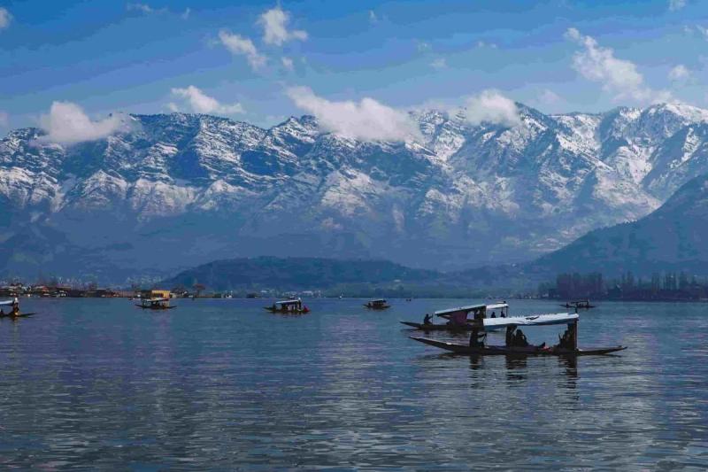 How to choose tour operator Kashmir - Shikara ride on Dal Lake Srinagar with snow-capped Himalayan mountains
