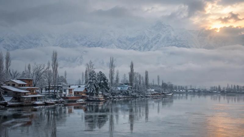 December Weather Across Kashmir with fog, snow-covered mountains and a freezing Dal Lake in Srinagar