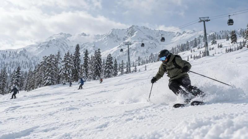 Skiers enjoying fresh snow beneath the Gulmarg Gondola during Kashmir in January