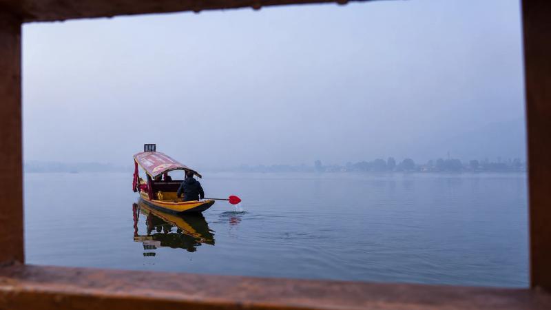 Two shikaras on misty winter lake, Dal Lake vs Nigeen Lake shikara ride in Srinagar