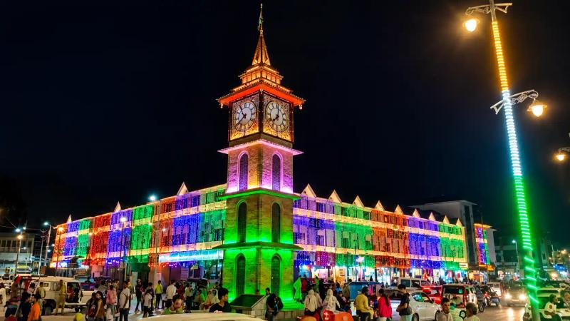 Srinagar clock tower lit in bright colours on Kashmir New Year night