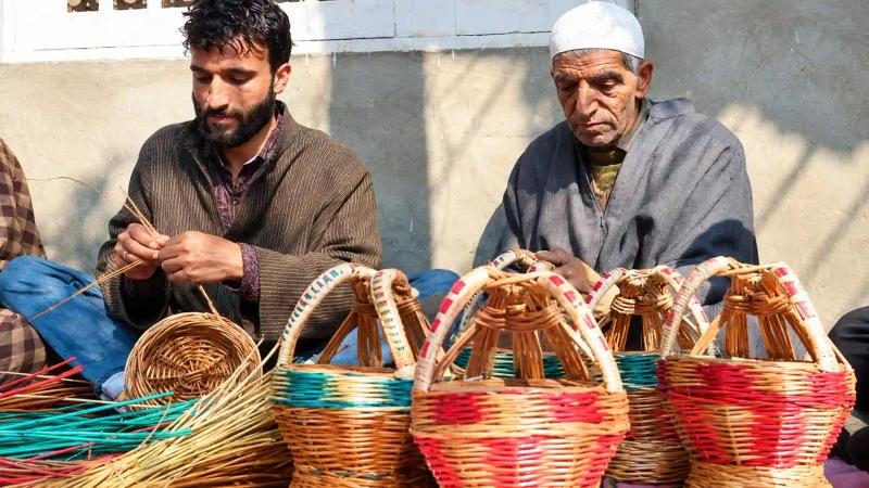 Kashmiri artisans weaving wicker kangris, traditional fire pots used in Kashmir winter food and culture