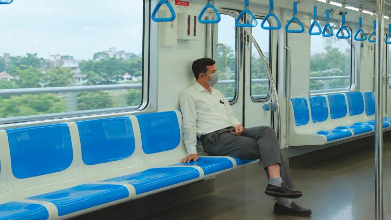 Passenger sitting in a calm train coach with blue seats, the cabin experience on Vande Bharat Srinagar in winter