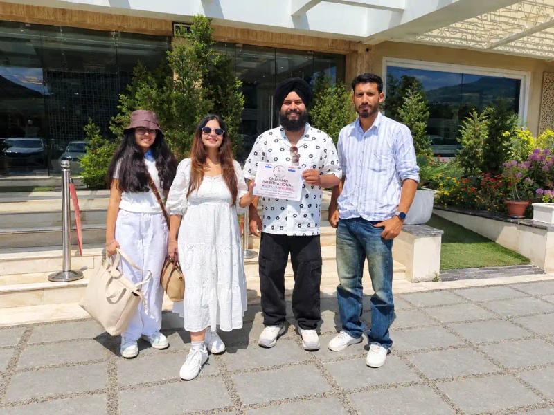 Guests and a local coordinator outside a hotel in Kashmir, Kashmir travel agency for family trips