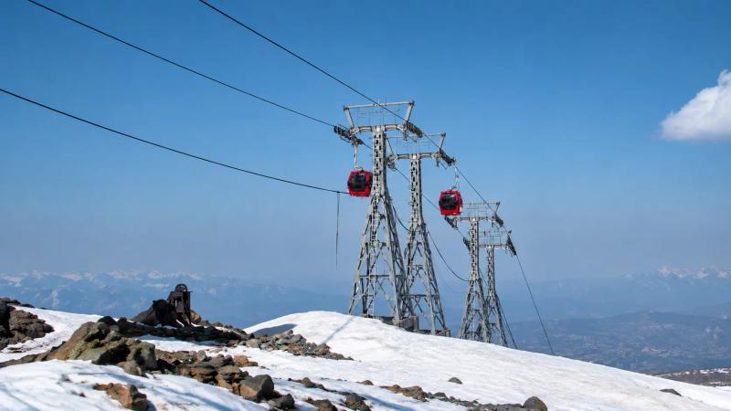 Red Gulmarg Gondola cabins above the snow, an activity that can pause in Kashmir Winter Packages