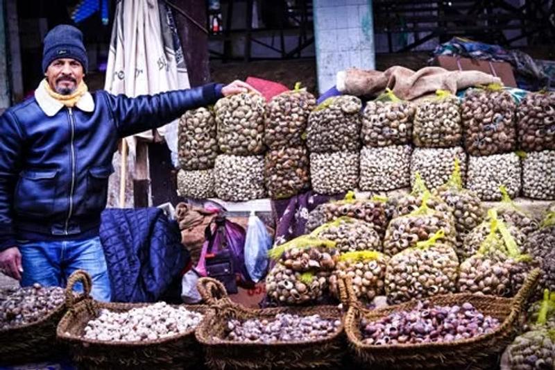 Vendor selling dried vegetables and dry fruits in a market, part of Kashmir winter food and culture