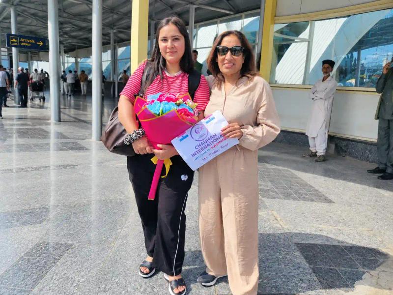 Traveller welcomed with flowers at airport arrivals in Kashmir by a Kashmir travel agency for family trips