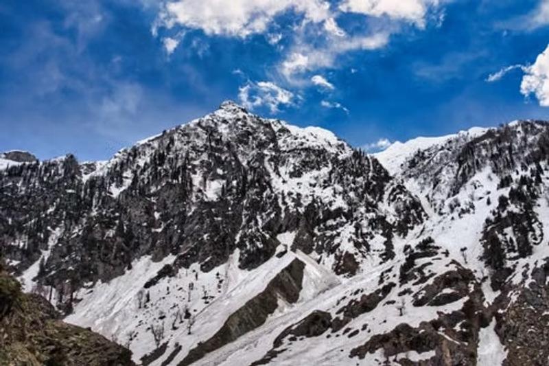 How to Reach Gurez Valley through scenic snow-covered mountains and rugged Himalayan landscapes.