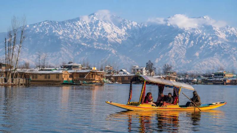 Kashmir in December with tourists enjoying a Shikara ride on Dal Lake in Srinagar