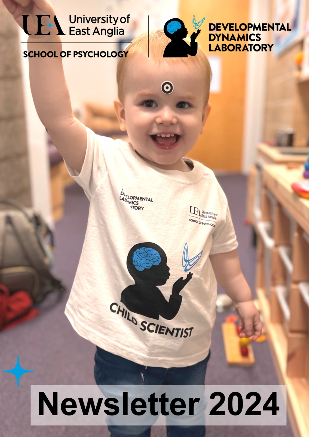 UEA Developmental Laboratory Newsletter 2024 Cover showing a child scientist wearing a lab t-shirt smiling