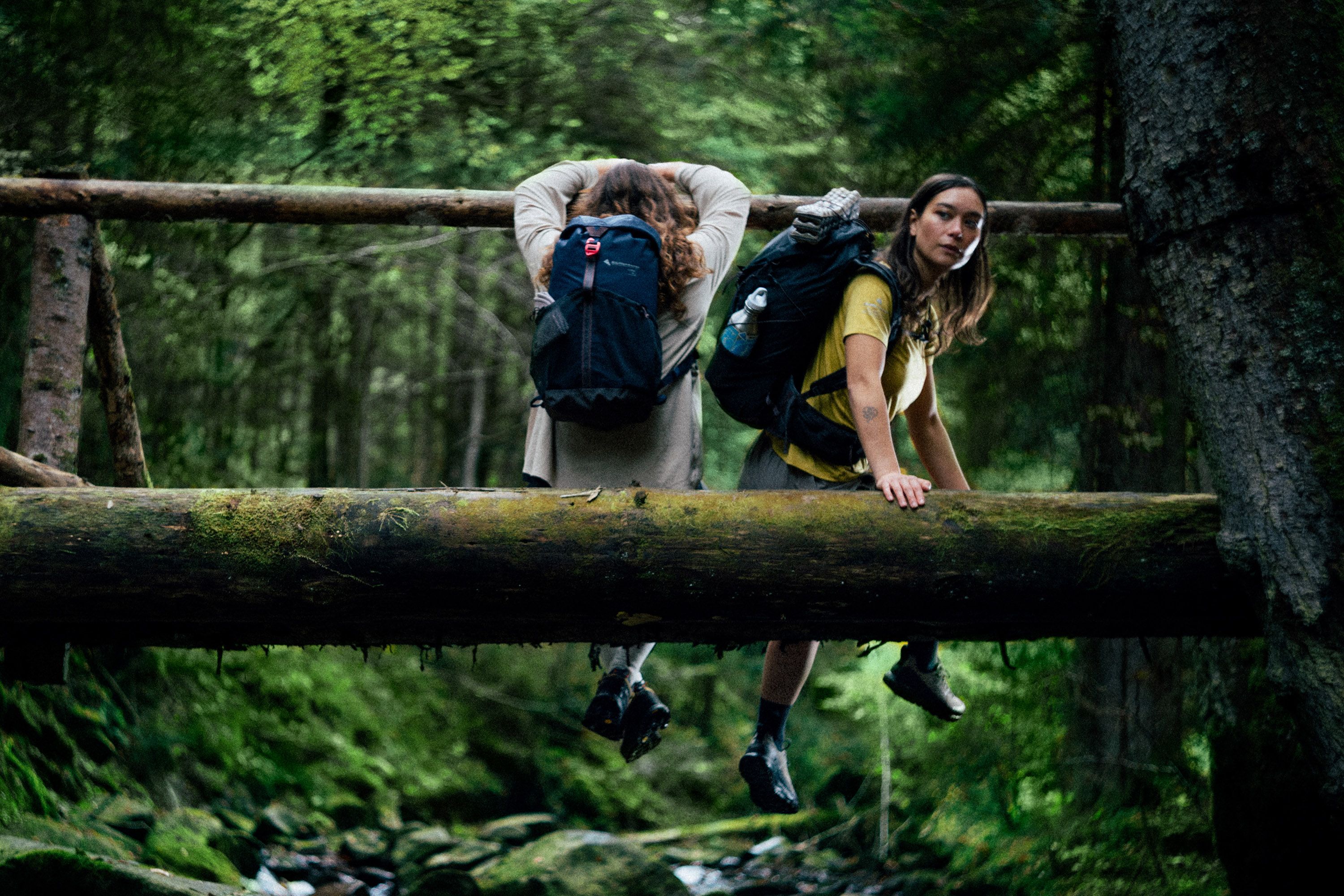 Man and woman sitting on a log
