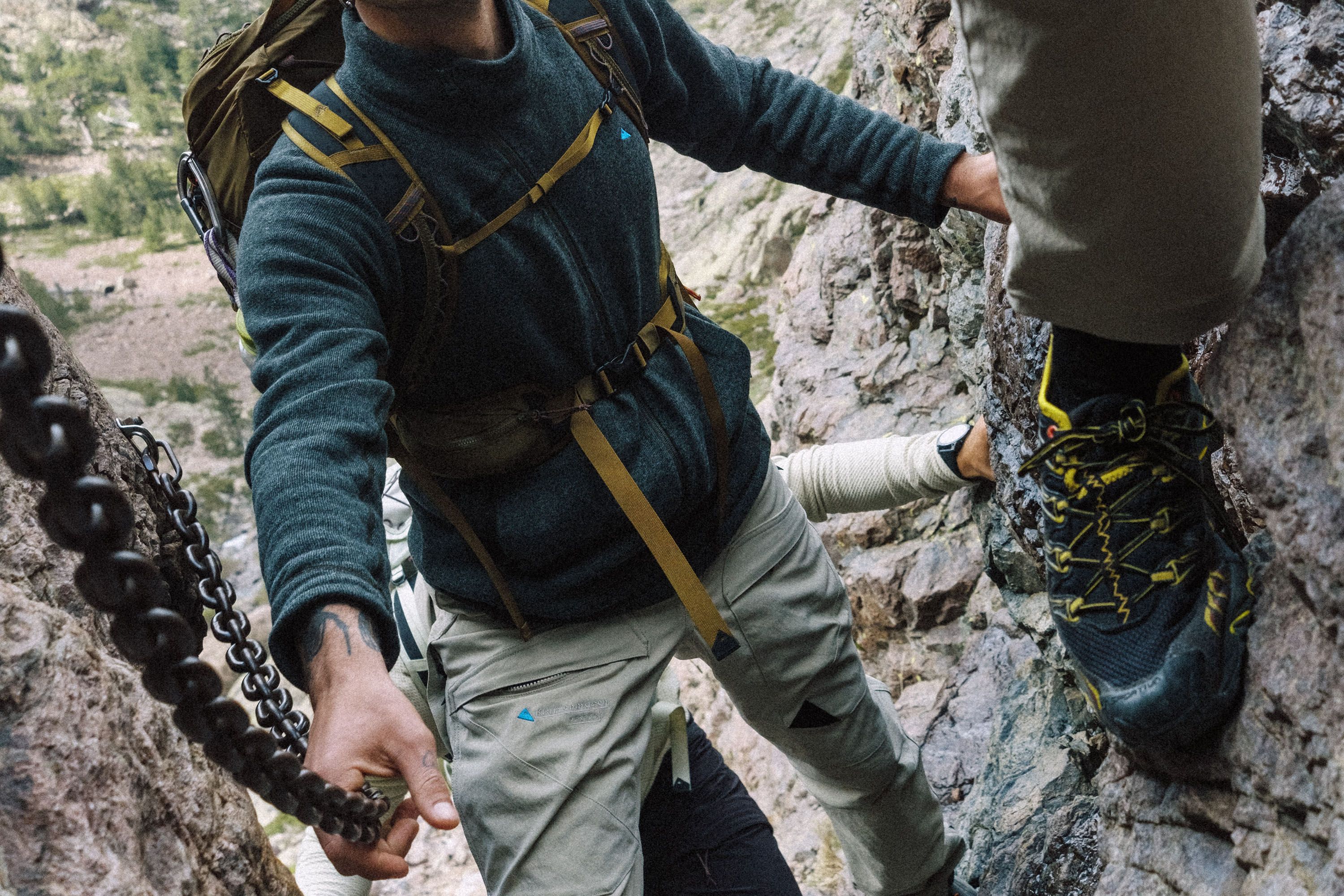 Man standing in the woods closing his jacket