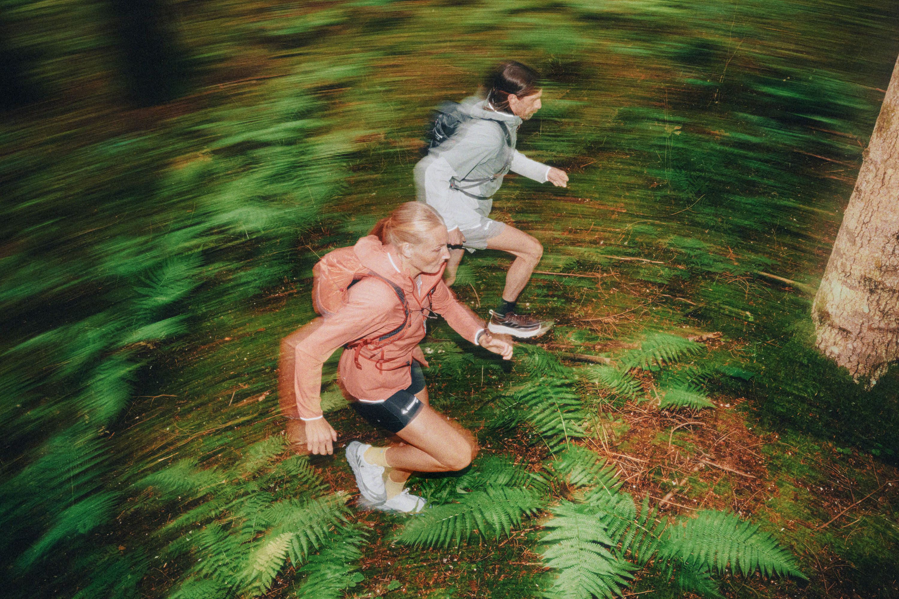 Man and woman running in the forest