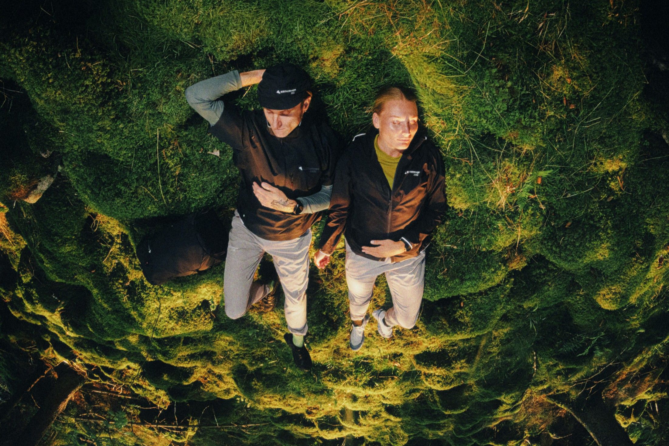 Man and woman laying in the grass