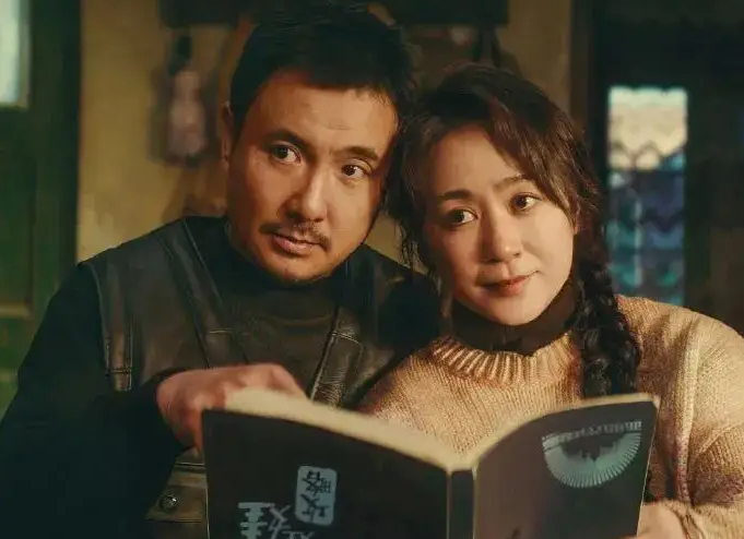 A scene from Successor showing the parents looking at a book together