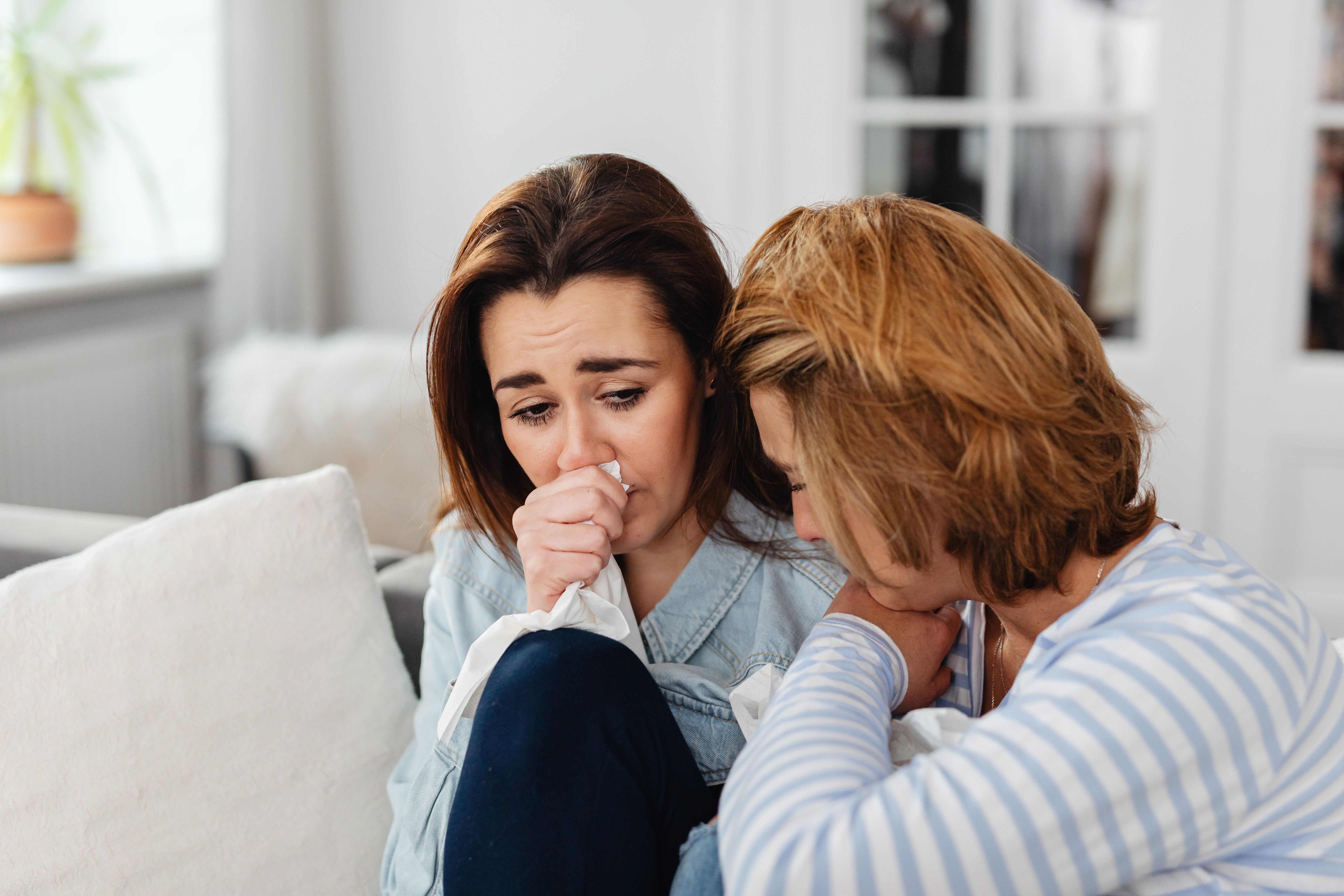 Image Grieving woman comforted by her mother after the wrongful death of a family member in Houston, Texas