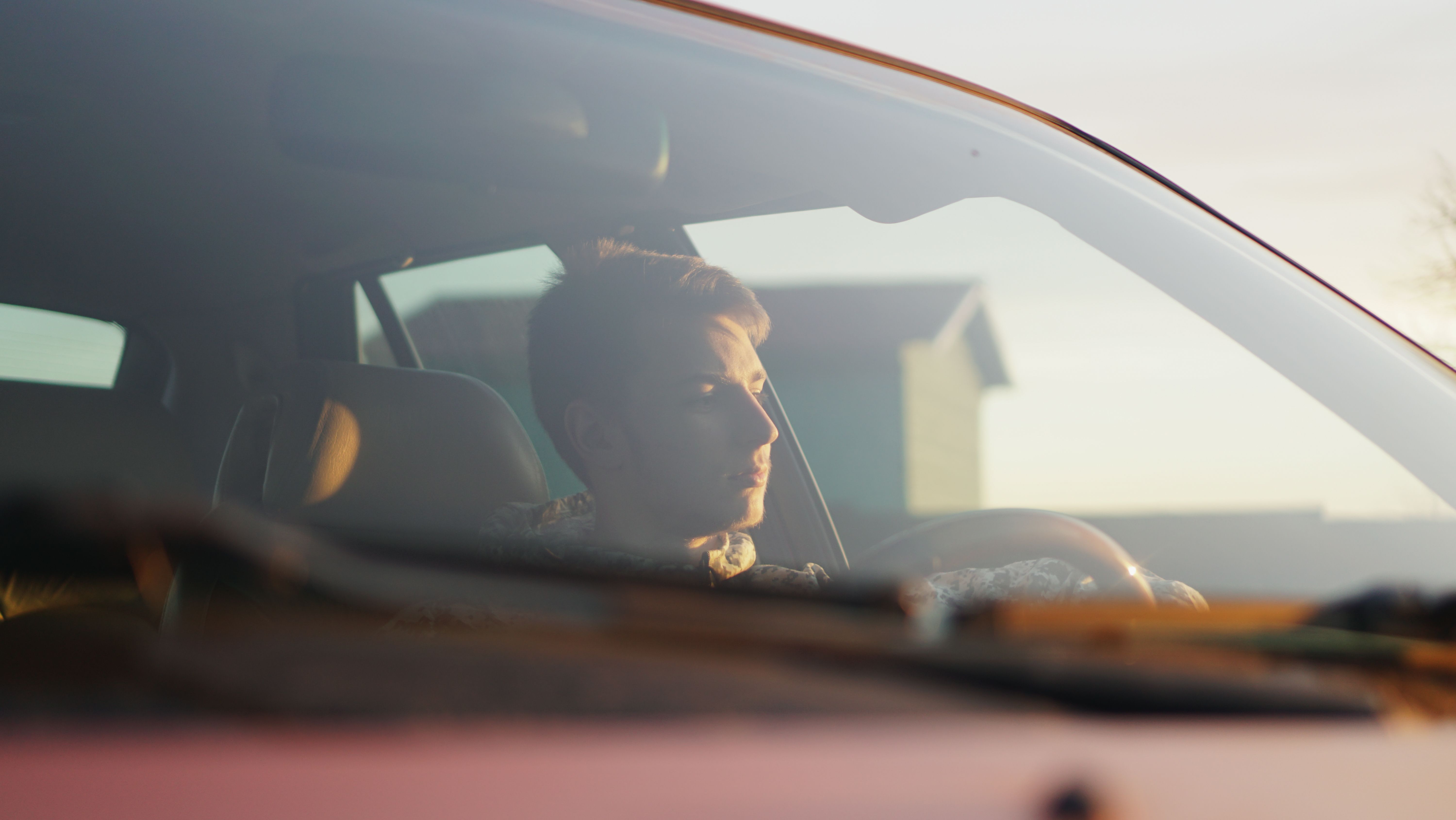 Young Texas driver behind the wheel at sunset, illustrating new teen drivers returning to busy roads during back-to-school season.