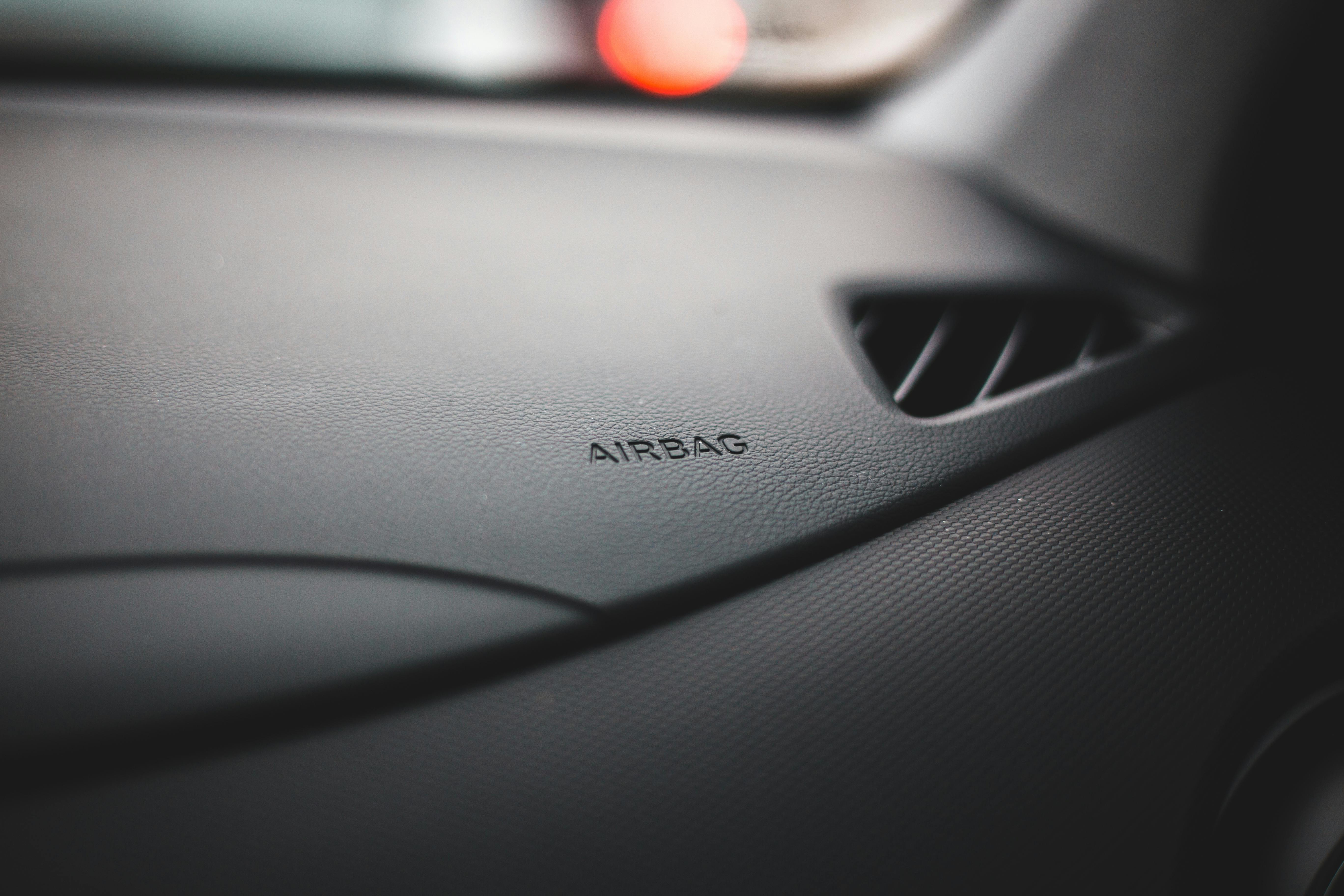 Close-up of a vehicle airbag panel for a blog explaining defective airbag injury claims after Dallas car accidents.