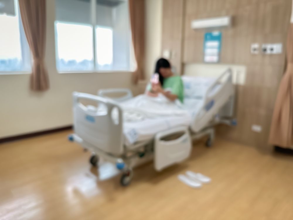 Patient sitting alone in a hospital bed highlighting risks of hospital understaffing and delayed care