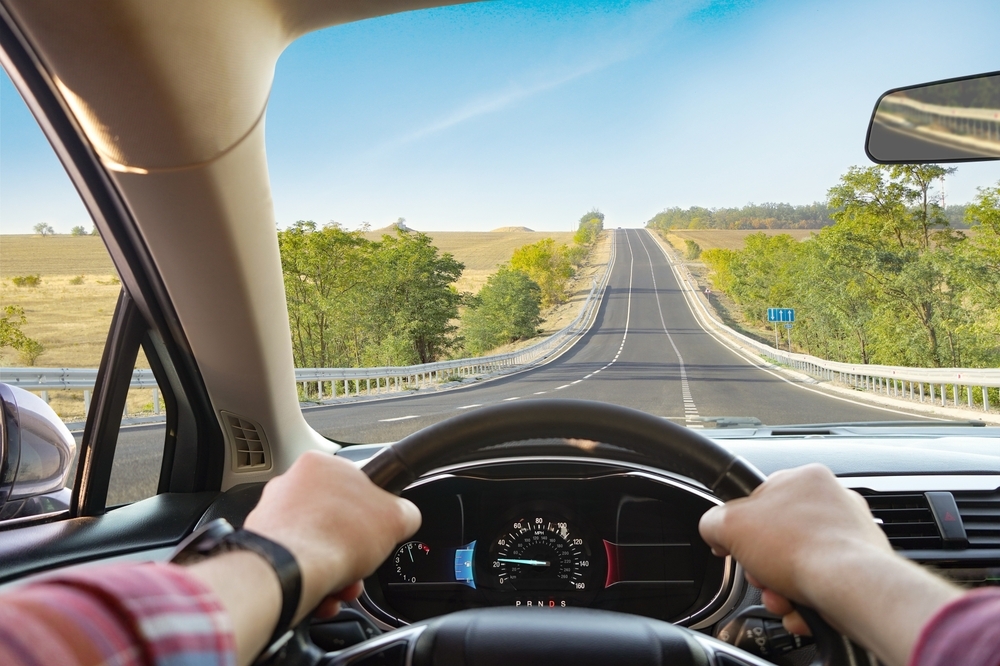 Image Driver’s perspective on a Texas highway heading toward South Padre Island, representing travel and risk of a Texas car accident during spring break