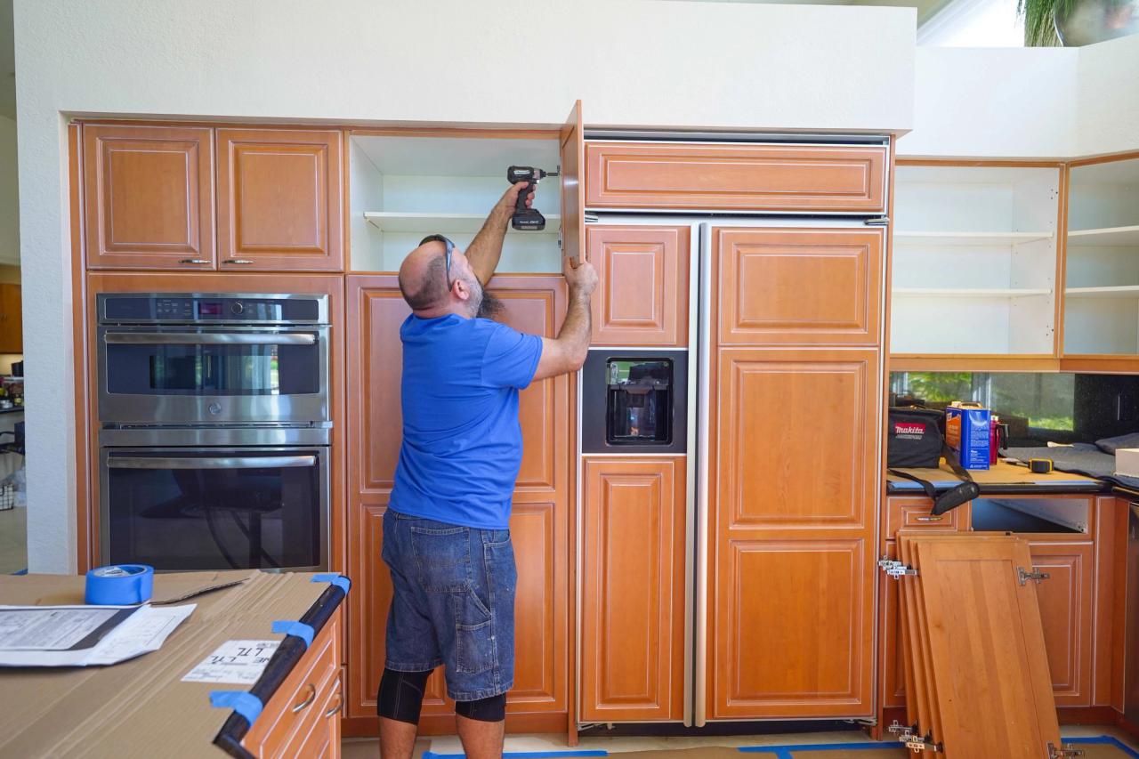 man refacing kitchen cabinets