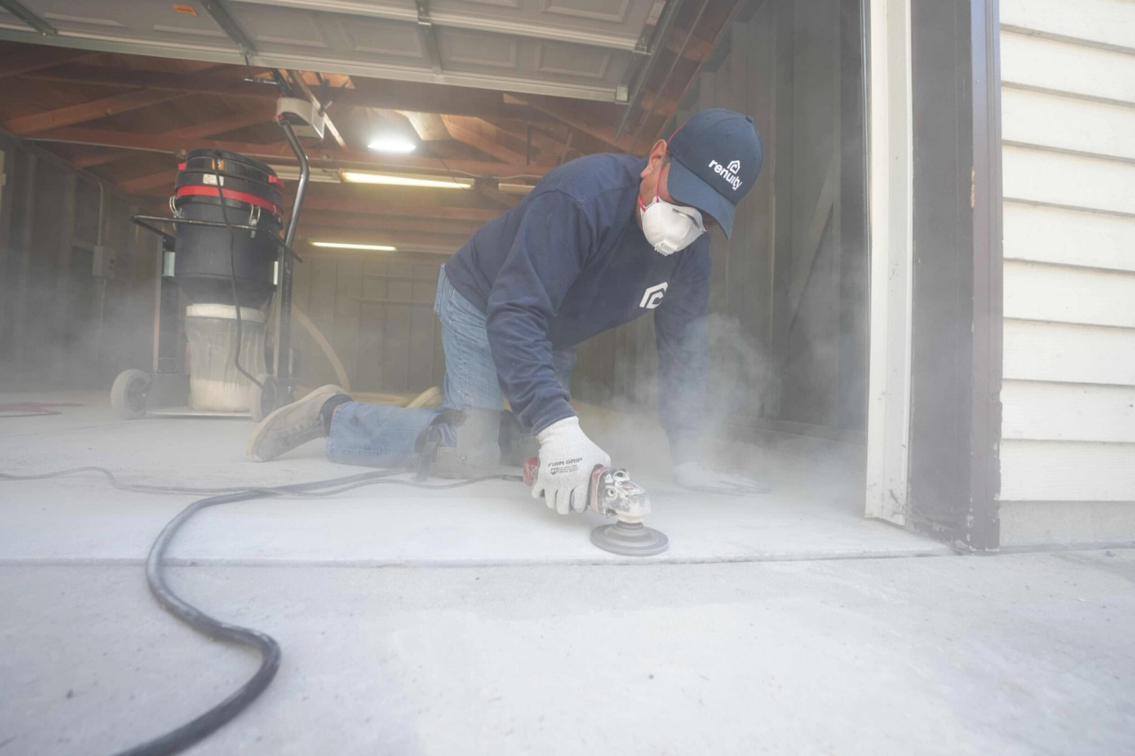 grinding concrete floor to prepare it for polyurea garage floor coating installation
