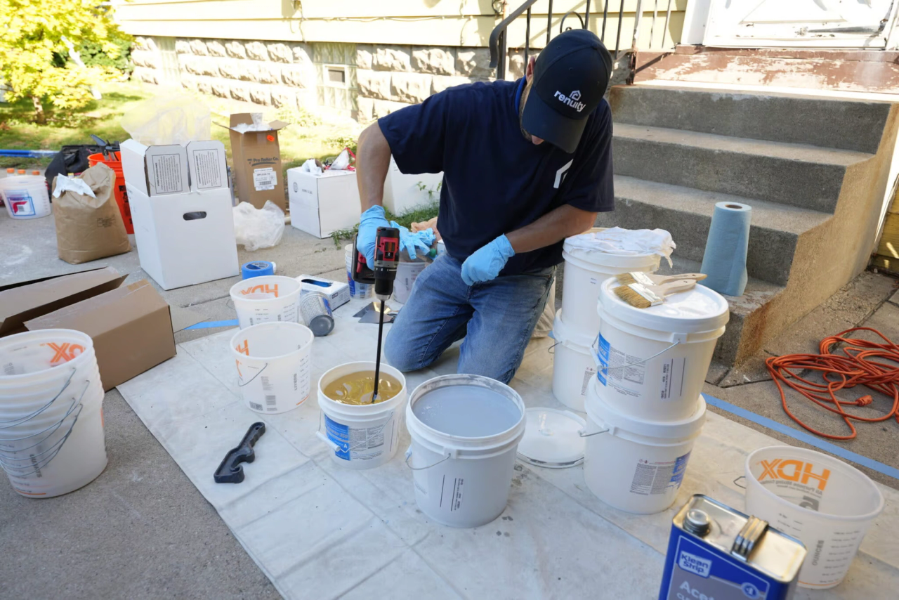 Renuity installer mixing polyurea flooring chemicals