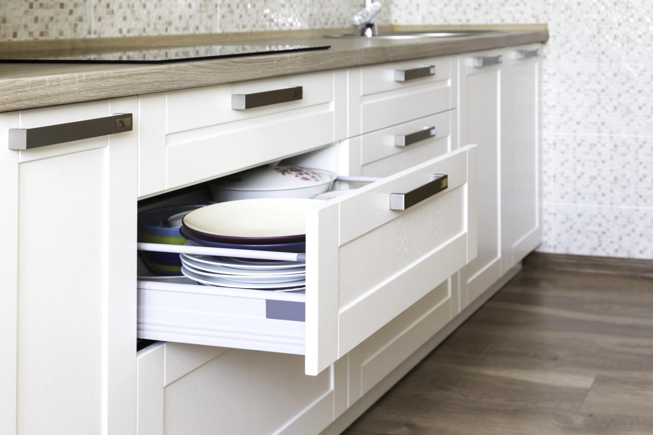 closeup of white kitchen cabinet with drawer open