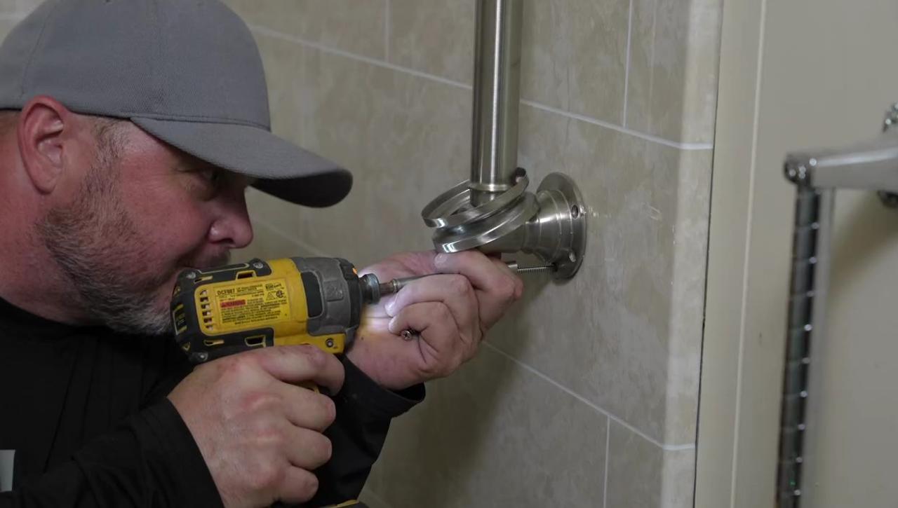 contractor installing grab bar