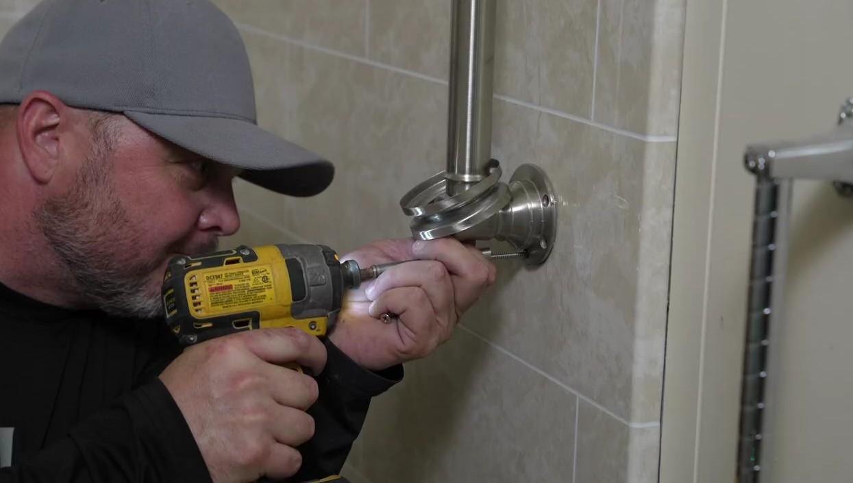 contractor installing grab bar