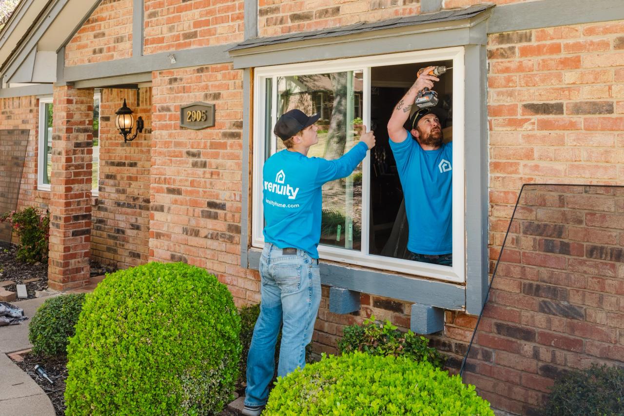 Renuity window installers installing a new white vinyl window