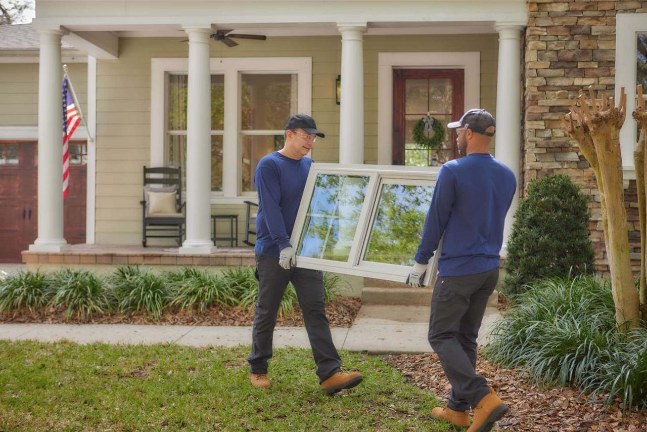 Renuity installers carrying a new replacement window