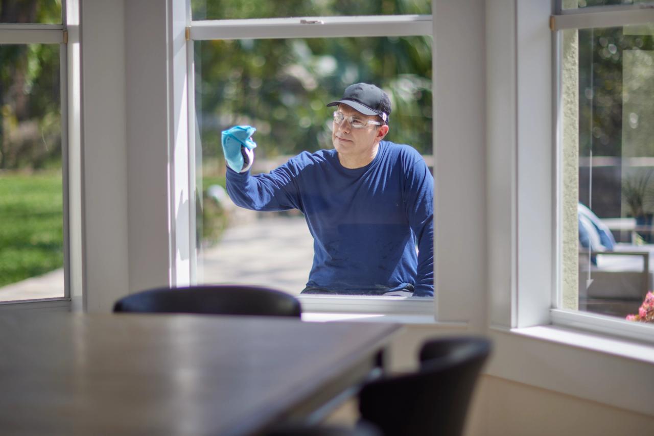 contractor wiping down a newly installed vinyl window