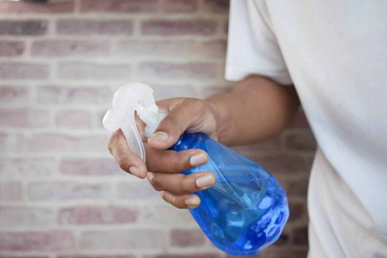 man holding a spray bottle