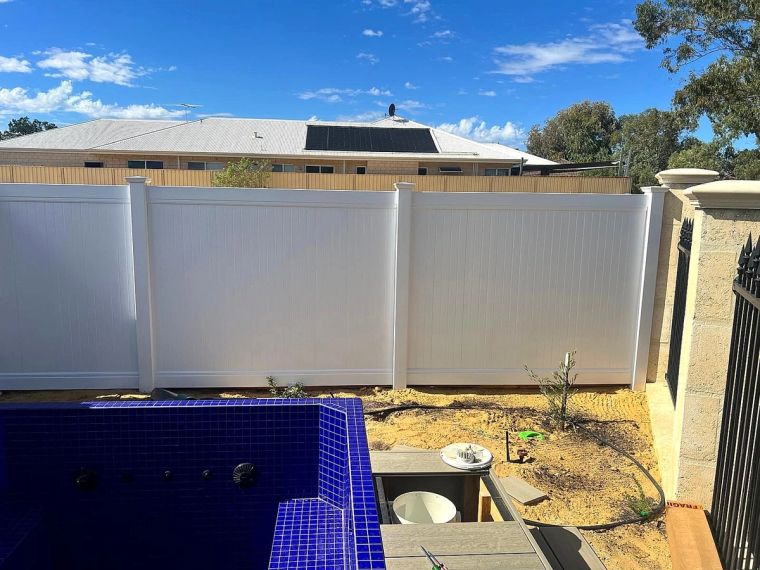 White PVC boundary fencing along a Perth Hills backyard