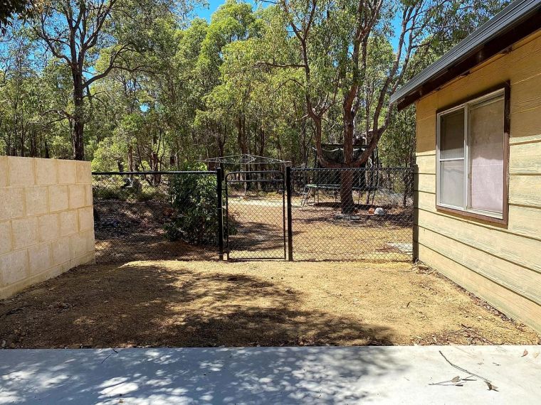 Black chain-mesh security fencing and gate beside a shed on a Perth Hills property