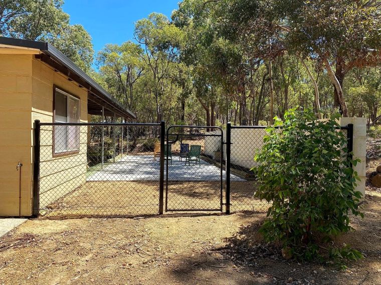 Black chain-mesh enclosure and gate around a paved yard on a Perth Hills property