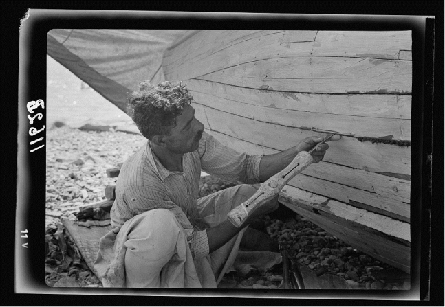 Loading drag net on boat and Tiberias fisheries. July 1940.